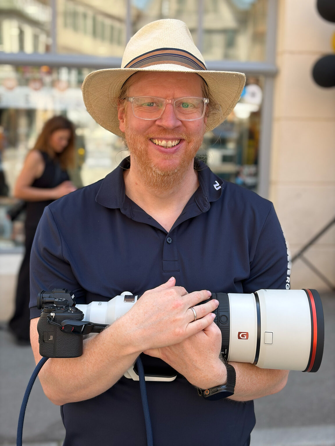 Fine art photographer Philipp Elverfeld holding the Sony FE 100-400mm F4.5-5.6 GM OSS telephoto lens mounted on a Sony Alpha 7R VI camera.