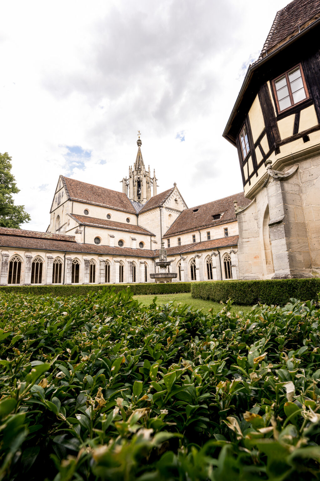 Fine art photograph of the historic courtyard at Bebenhausen Abbey near Tübingen, Germany. Featuring Gothic cloisters, monastery gardens, medieval architecture, and the iconic church tower.