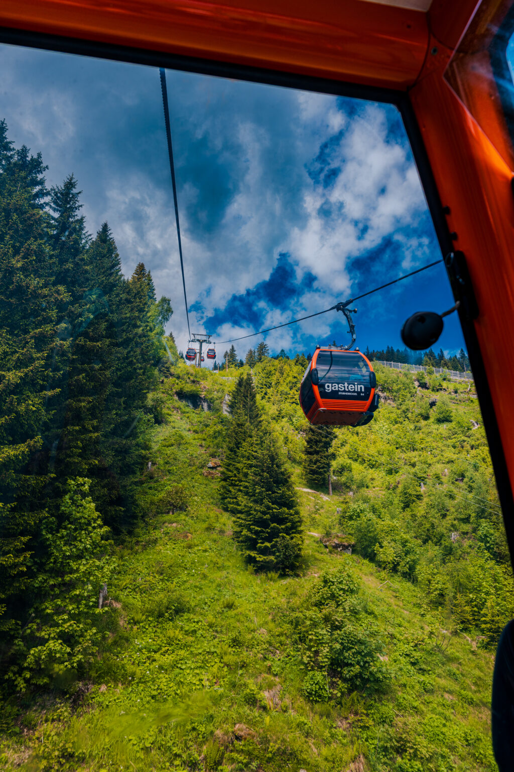 Stubnerkogel Cable Car ascending above the forests of Bad Gastein in the Austrian Alps.